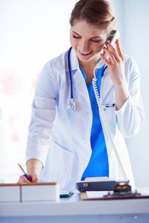 205204942-serious-doctor-on-the-phone-in-her-office